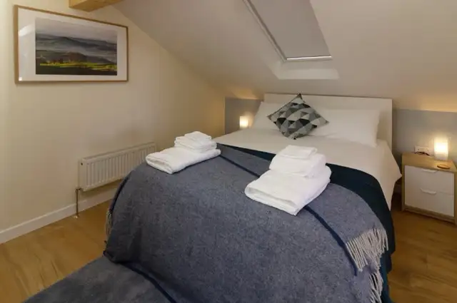 King size bedroom at The Studio Cheddar with hotel-quality linen and sweeping countryside views — romantic luxury couples retreat near Cheddar Gorge, Draycott, Somerset